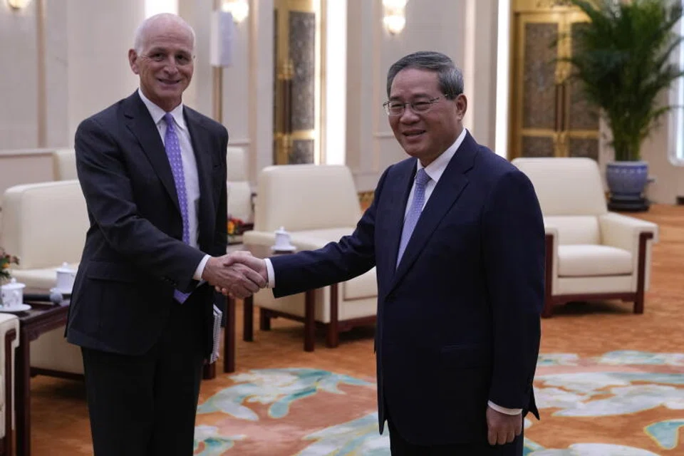 Representative Adam Smith (L), a Democratic representative from Washington, poses for a photo with Chinese Premier Li Qiang at the Great Hall of the People in Beijing.