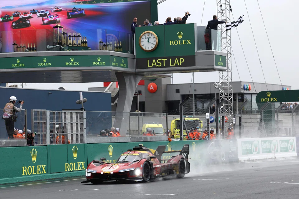 Danish driver Nicklas Nielsen crosses the finish line to win the Le Mans 24-hours endurance race for Ferrari.