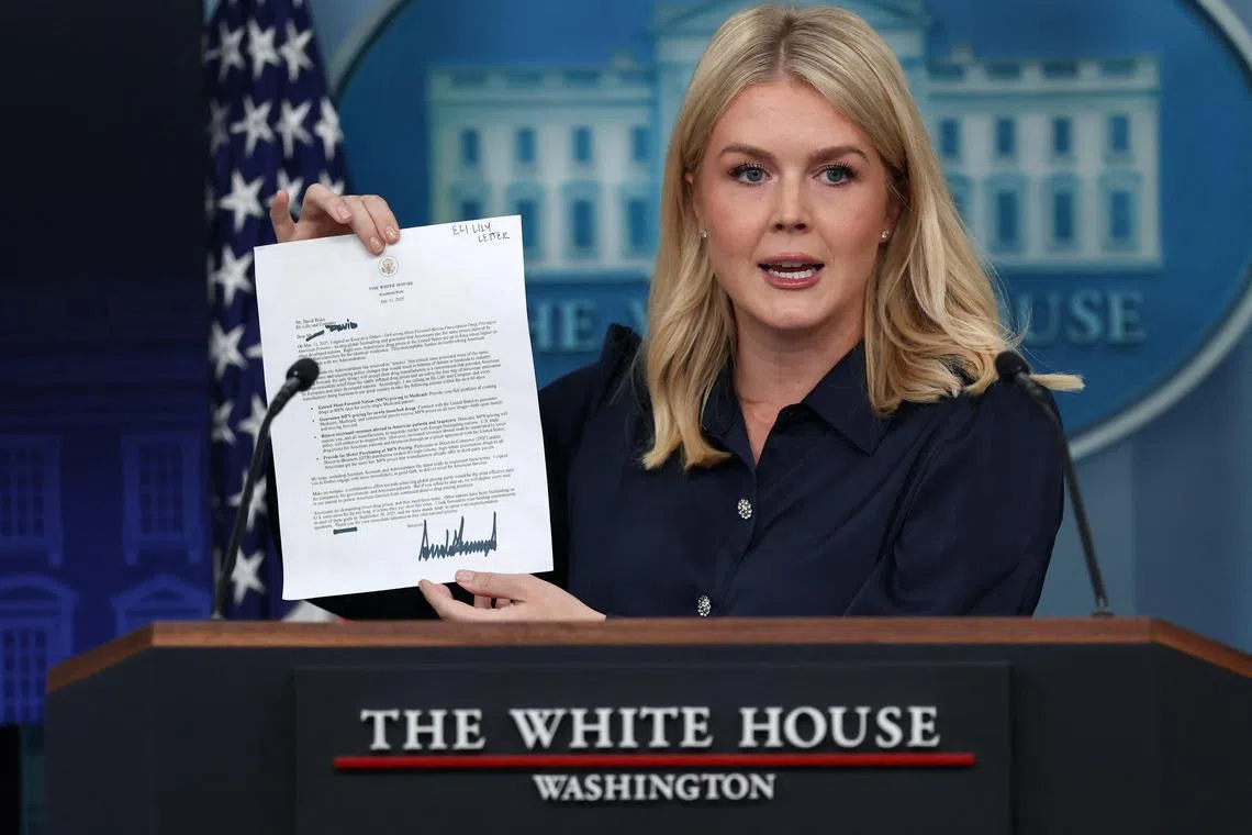 White House Press Secretary Karoline Leavitt holds US President Donald Trump's letter to Eli Lilly CEO David Ricks during a press briefing at the White House in Washington, D.C., July 31, 2025. 