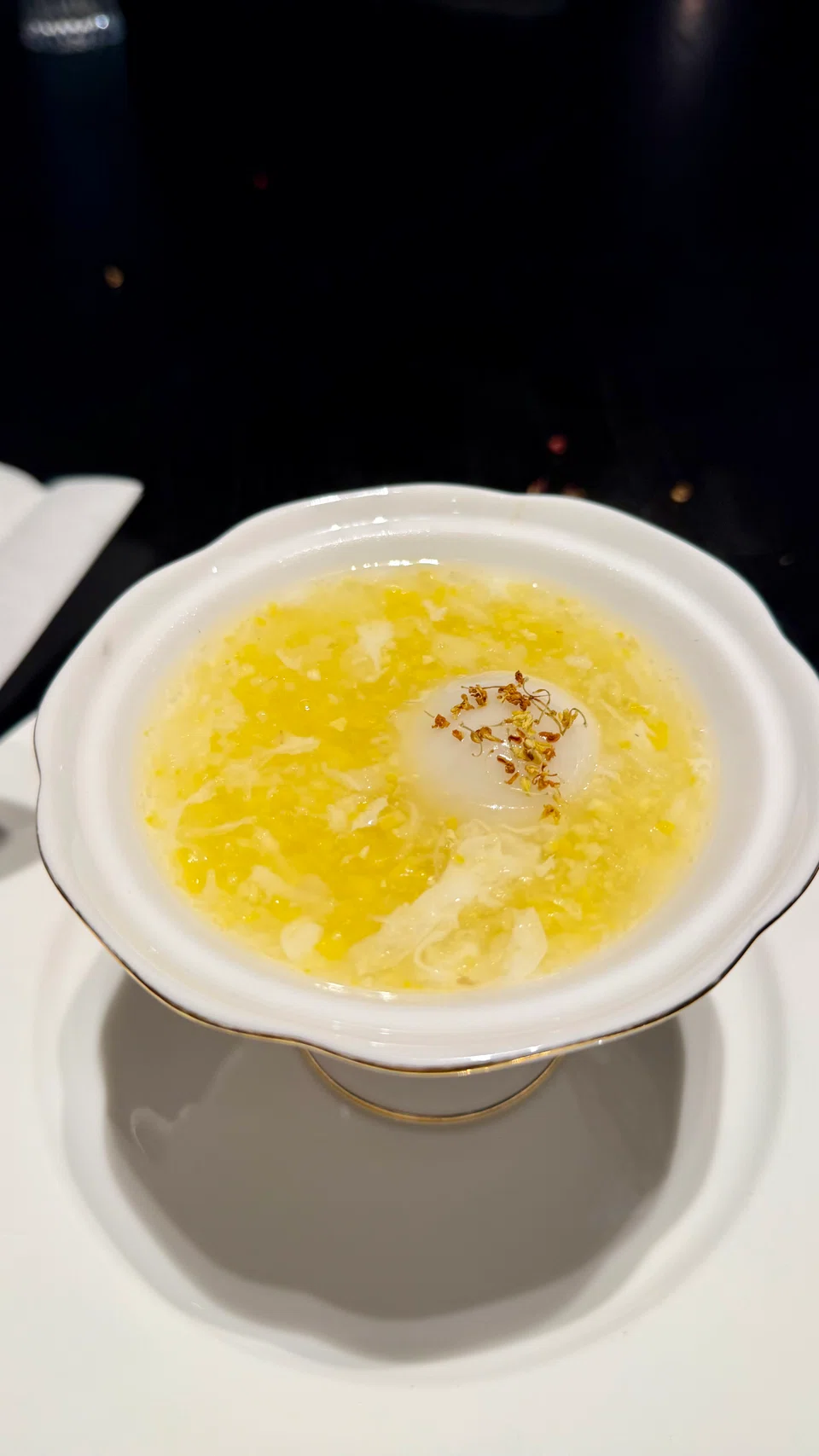 Black sesame glutinous rice ball in sweet waterchestnut soup.