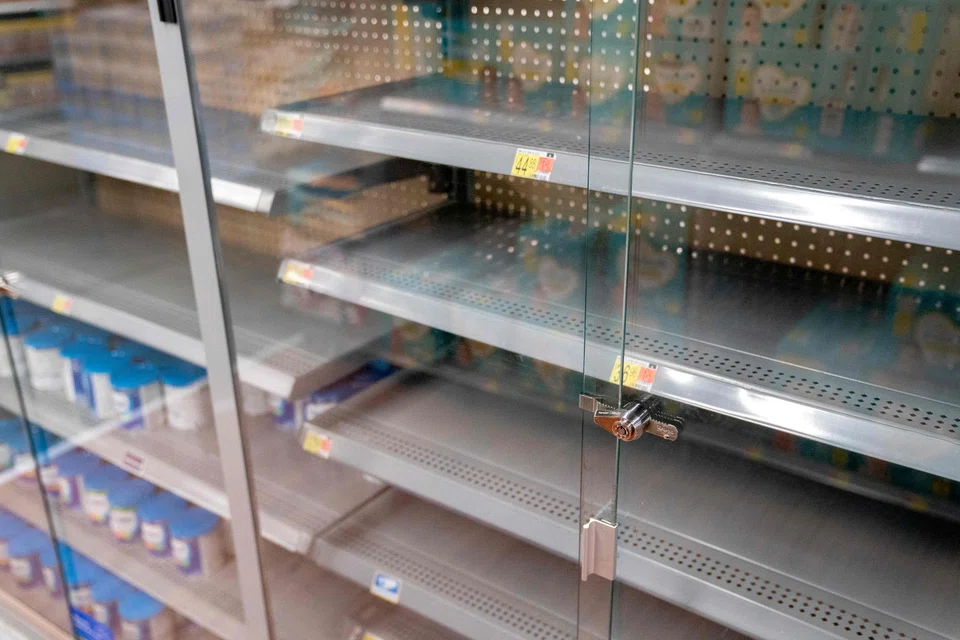 Grocery store shelves where baby formula is typically stocked are locked and nearly empty in Washington, DC, on May 11, 2022. 