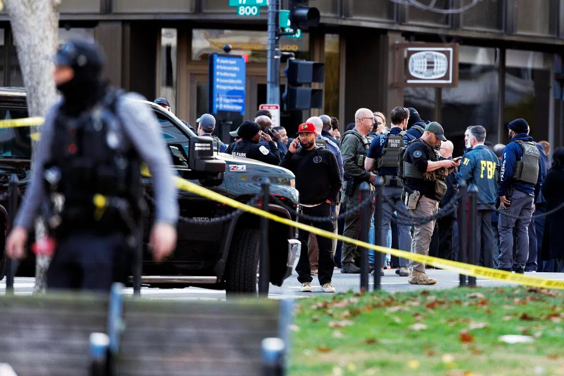 Law enforcement officers stand close to the scene where two West Virginia National Guard members were shot in Washington, D.C., Nov 26, 2025.