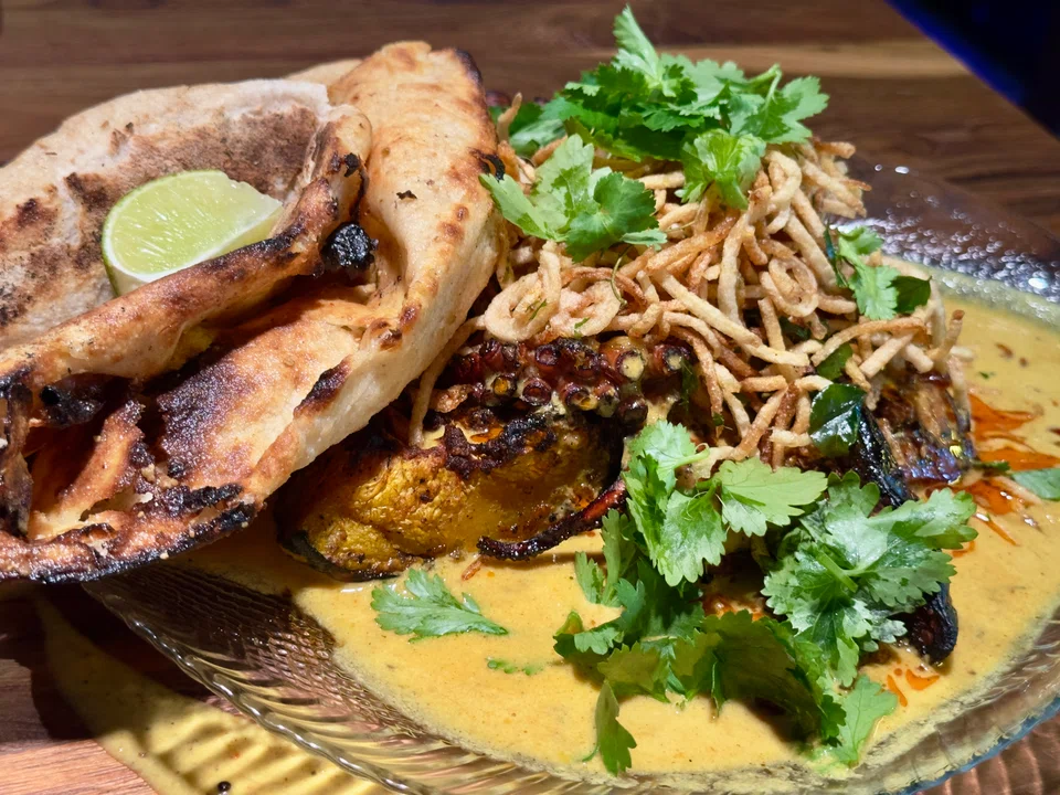 Octopus in yellow turmeric curry sauce.