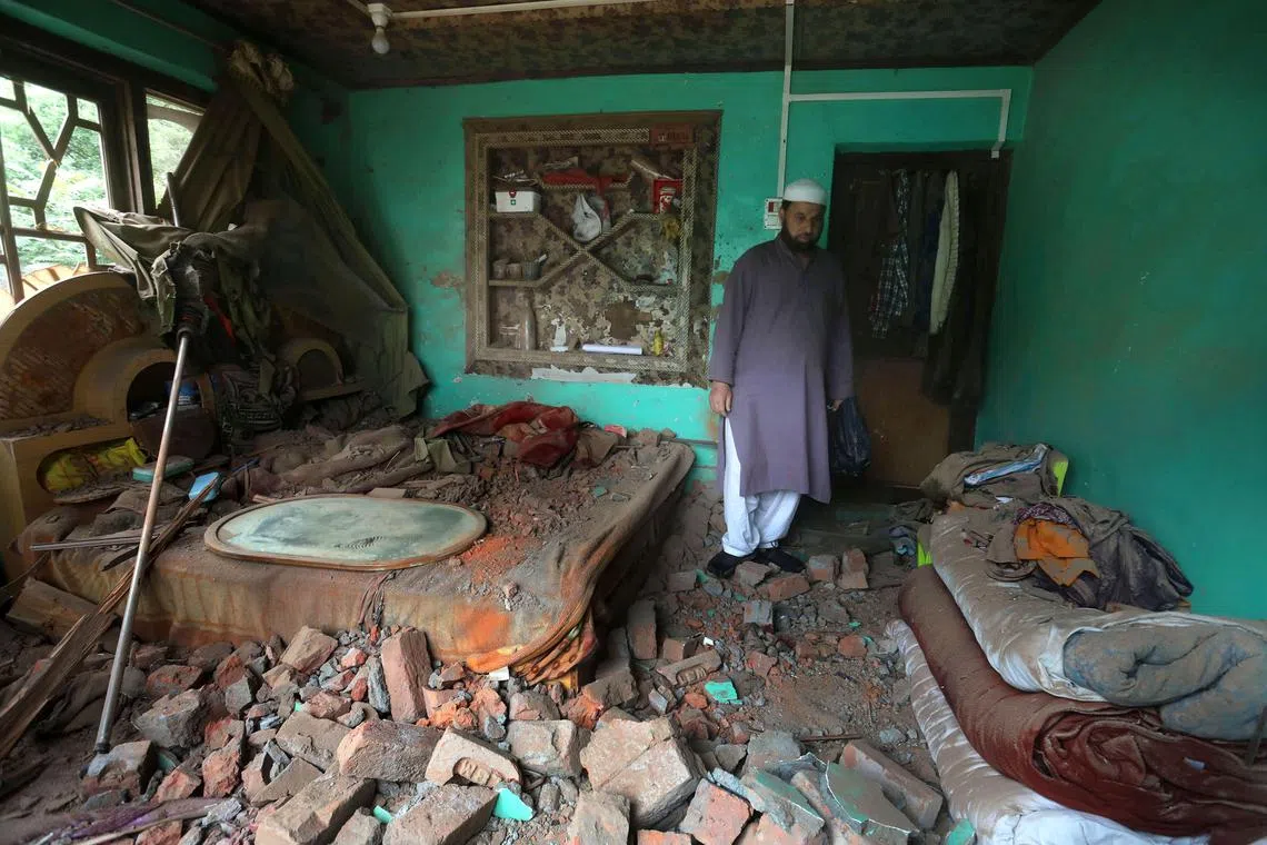 A Kashmiri villager inspects a house damaged after cross-border shelling from Pakistan, at Gingal village in Uri, India-administered Kashmir, May 9, 2025. 