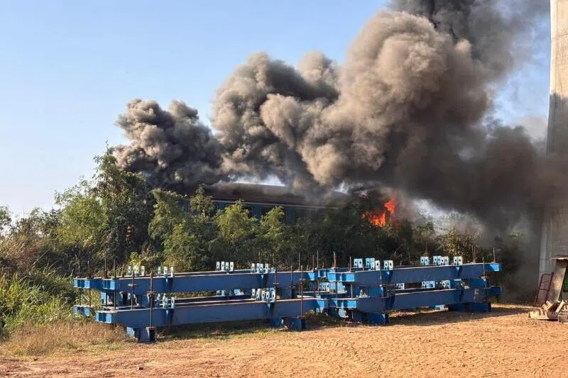 The crane was working on a high-speed rail project when it collapsed and hit the passing train, causing it to derail and briefly catch fire.