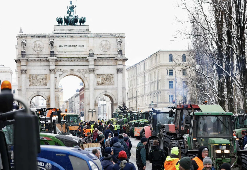 Farmers with their tractors at Odeonsplatz square in Munich's city centre, taking part in protests against the federal government's austerity plans on Monday (Jan 8).  