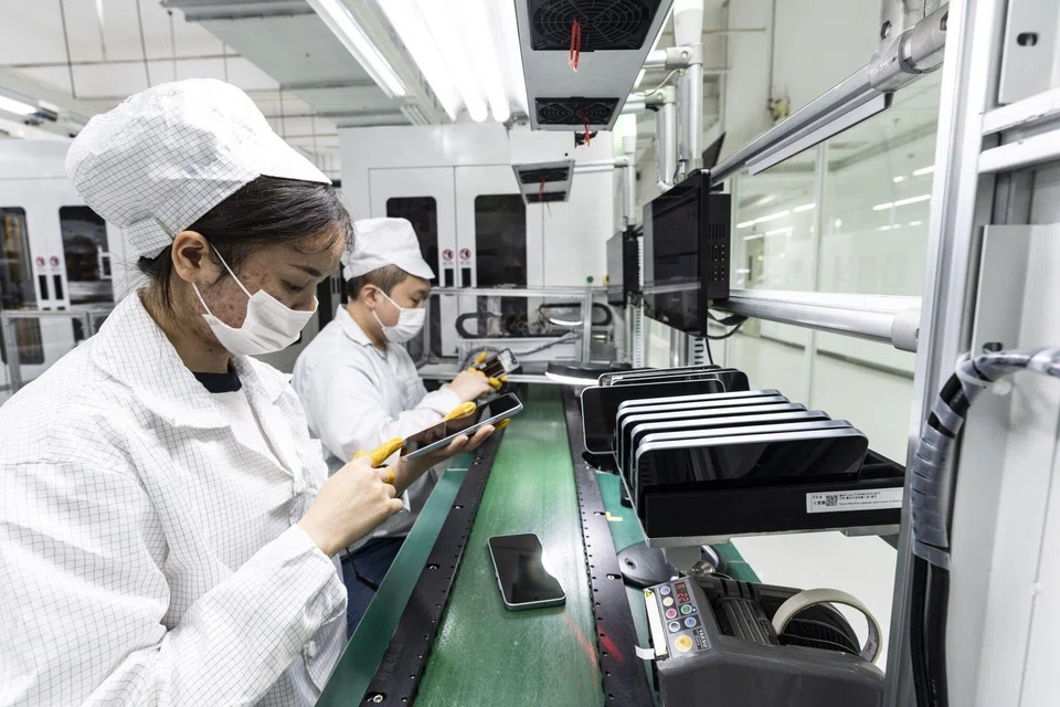 Workers on the production line for smartphones at the Oppo factory in Dongguan, China, Feb 27, 2026.  