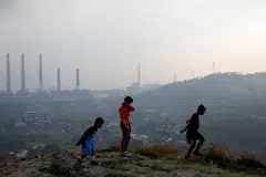 Youths at a village near a coal-fired power plant in Suralaya, Banten province, Indonesia. South-east Asia, home to the fourth-largest and one of the youngest fleets of coal-fired power plants with an average age of less than 15 years, faces a unique challenge in the race to decarbonise.