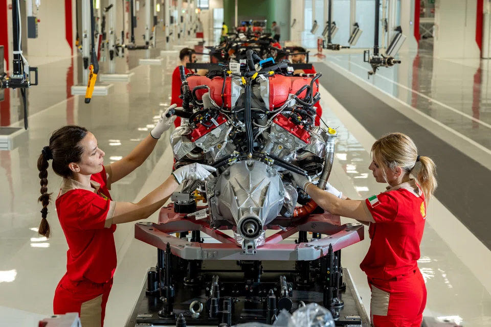 Workers at Ferrari’s new assembly plant in Maranello putting together an engine for a Purosangue.