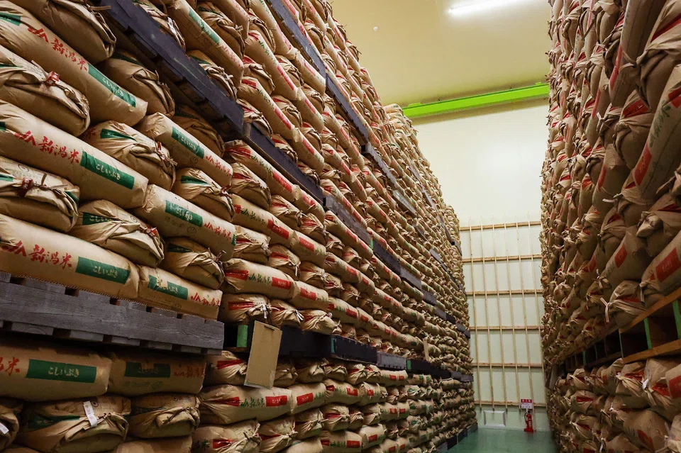 Government-stockpiled rice piled up at a warehouse in Saitama prefecture, Japan, Feb 18, 2025. Rice shortages driven by factors from poor harvests caused by hot weather to panic-buying over a “megaquake” warning last summer have caused prices to nearly double over a year.
