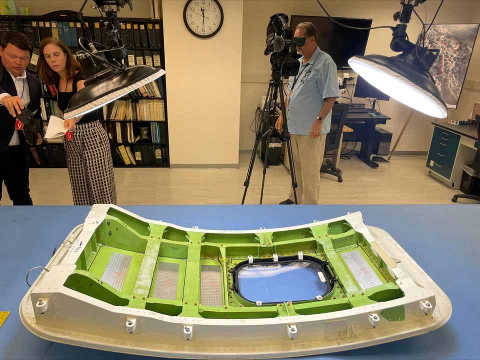 Members of the news media view the Alaska Airlines Flight 1282 door plug at the National Transportation Safety Board (NTSB) materials lab in Washington, US, July 30, 2024. 