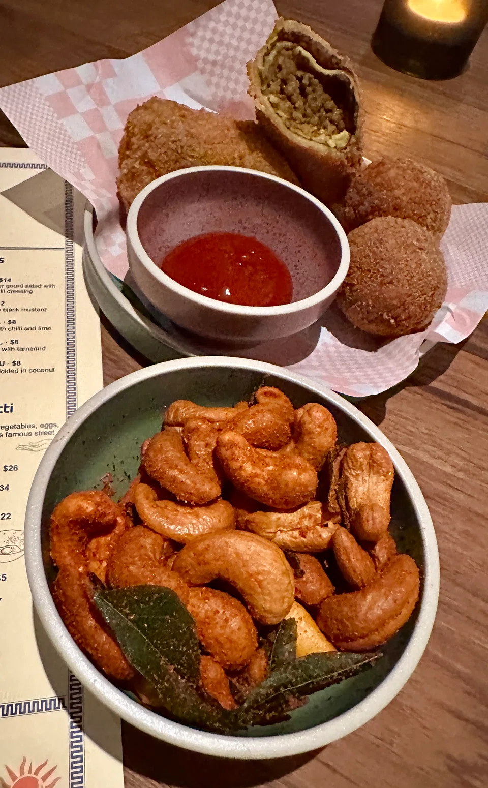 Sri Lankan snacks of devilled cashews, crab croquettes and mutton rolls.