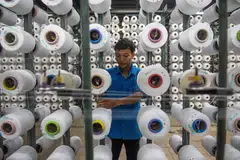 A worker arranges rolls of thread for a weaving loom at a textile factory in West Java, Indonesia, April 15, 2025. Indonesia, South-east Asia’s biggest economy and the world’s fourth most populous country, has an edge over its neighbours - the potential of its vast consumer market.