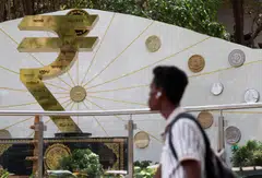 An installation of the Rupee logo and Indian currency coins outside the Reserve Bank of India (RBI) headquarters in Mumbai.