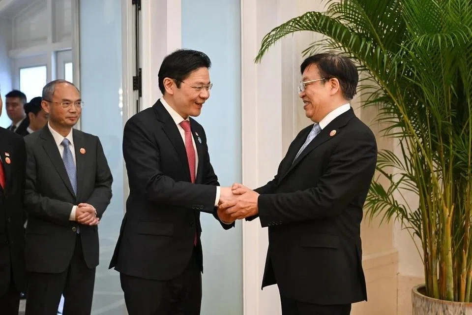 Prime Minister Lawrence Wong with Hainan Communist Party secretary Feng Fei on Mar 26. Both agreed that Singapore and Hainan have much to gain from cooperation.