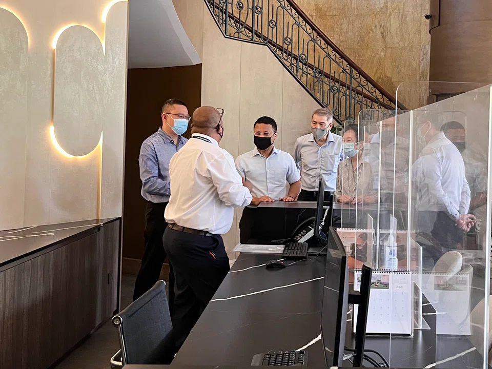 Minister for National Development Desmond Lee speaks to Azam from Primo Guards, the security team at Great World Serviced Apartments, which ran one of the pilots in the Singapore Business Federation's Lighthouse Project.