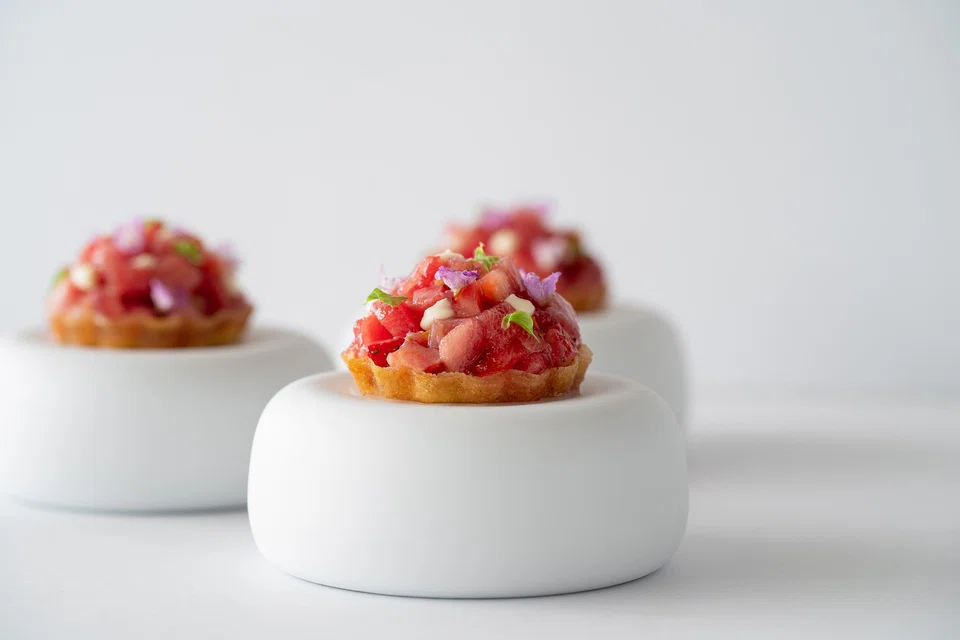 Vitello tonnato is reimagined as a tuna sashimi tart with strawberries and veal sauce.