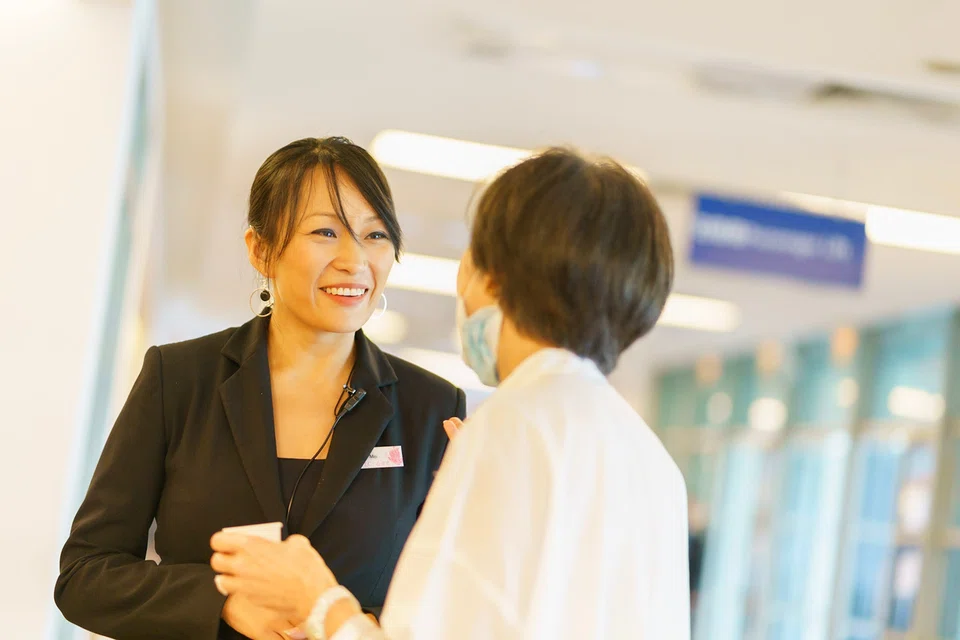 The Life Celebrant's Ang Jolie Mei spending a moment with the daughter of a deceased man after his funeral service.