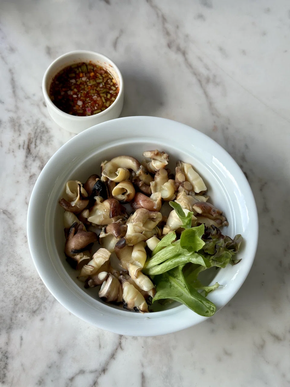 Slippery morsels of steamed conch snails.