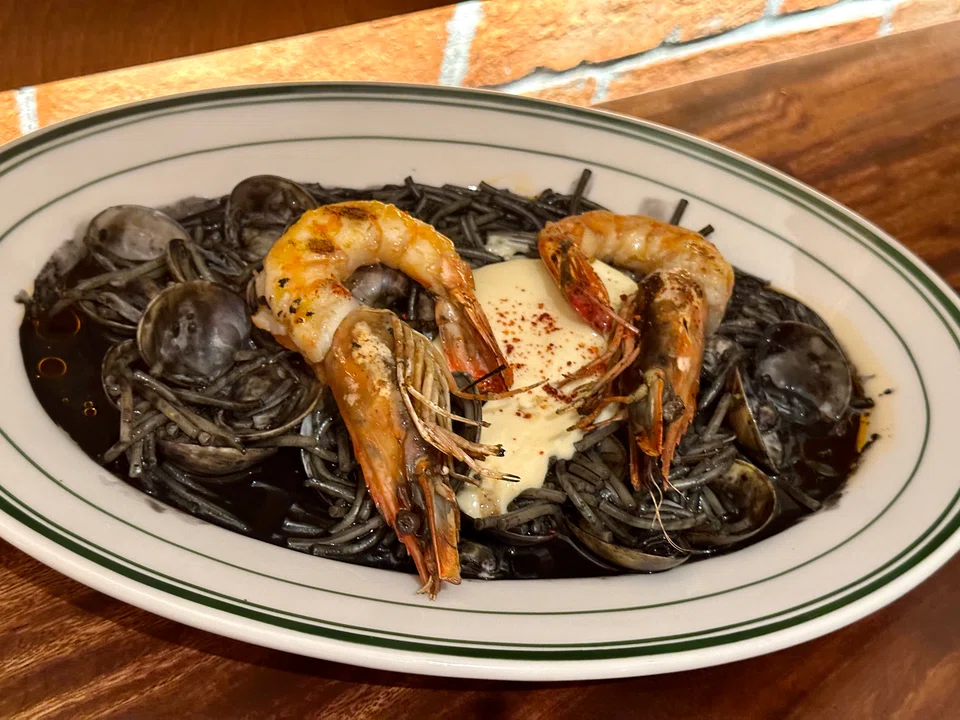Squid ink fideua pasta resembles Hokkien mee, but Spanish.