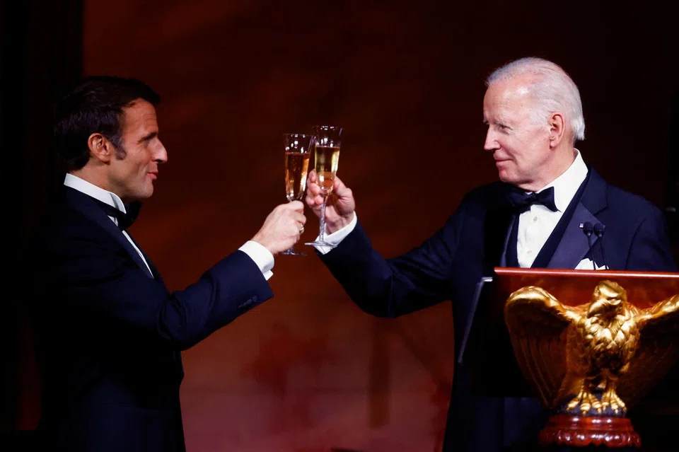 US President Joe Biden and France's President Emmanuel Macron raise their glasses to toast, at the state dinner for the Macrons at the White House on Dec 1. 