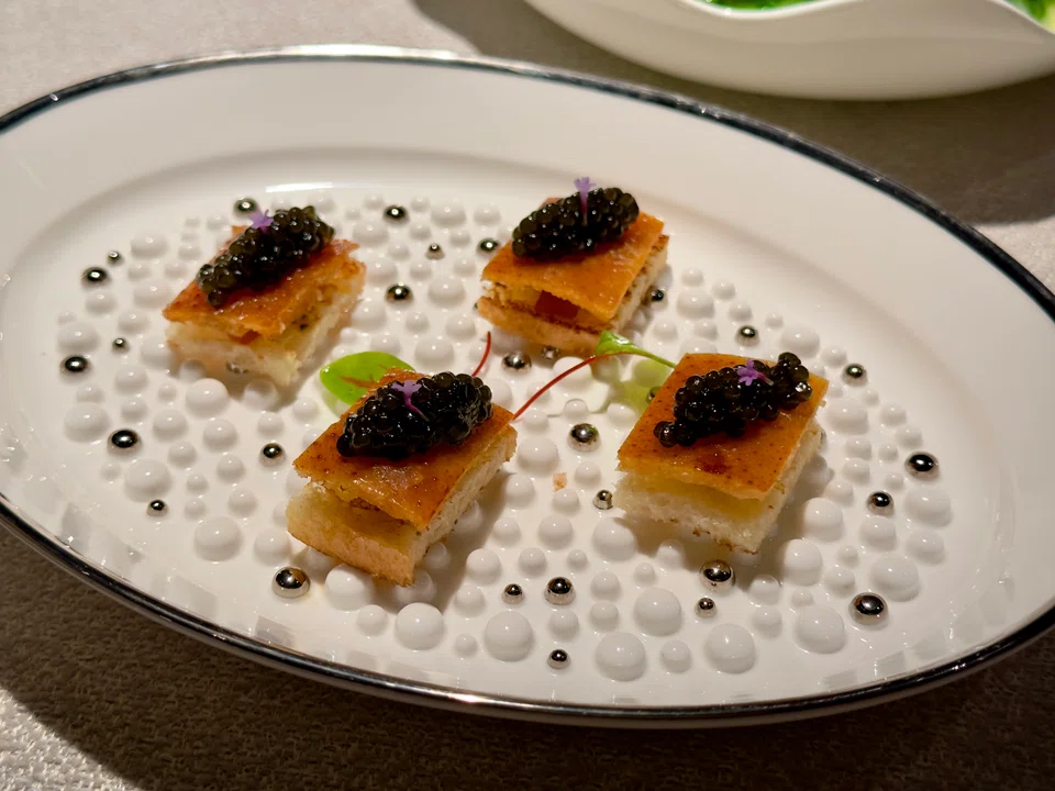 Peking duck skin on toast topped with caviar.