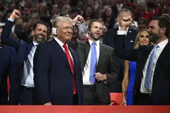 US former President and 2024 Republican presidential candidate Donald Trump (left) smiles as he is cheered on by US Senator from Ohio and 2024 Republican vice-president candidate JD Vance (right) and his sons Donald Trump Jr and Eric Trump during the first day of the 2024 Republican National Convention.