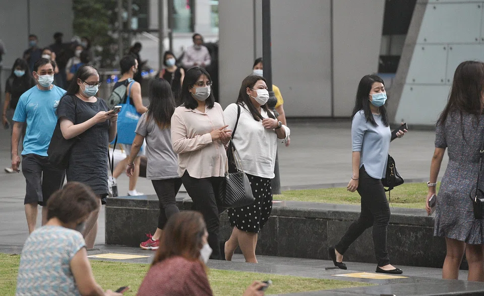 Office workers walking at Raffles Place after work in the evening on 8 March 2022.