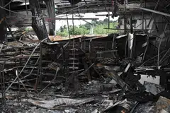 Damage from a fire caused by Cambodian artillery at a 7-11 convenience store is seen at a gas station in the Thai border province of Sisaket province.