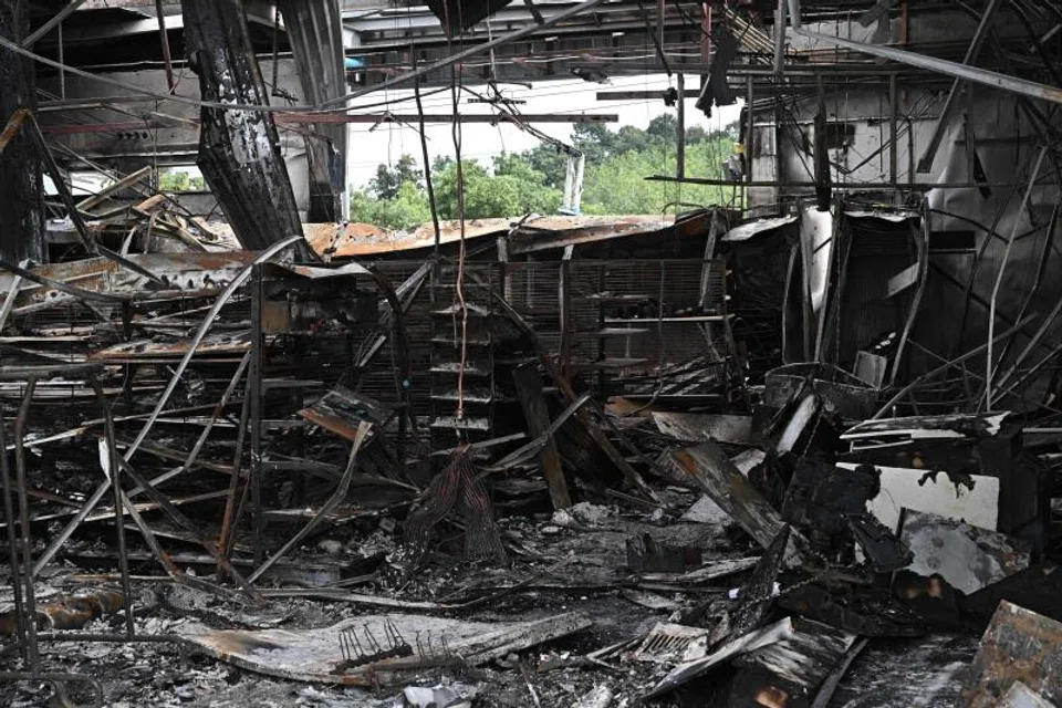 Damage from a fire caused by Cambodian artillery at a 7-11 convenience store is seen at a gas station in the Thai border province of Sisaket province.