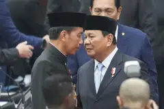 Widodo (left) talks to Prabowo after delivering his final state address on Friday; Widodo has been laying the groundwork for a seamless transition by supporting initiatives championed by Prabowo.