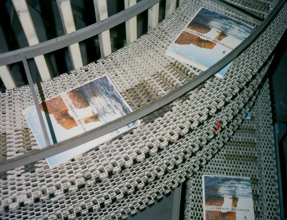 The most recent copy of Adventure Journal working its way up to a conveyor belt at BJ Bindery in Santa Ana, California. The magazine is part of a burst of small-batch, independent outdoors magazines that are finding analogue success.  