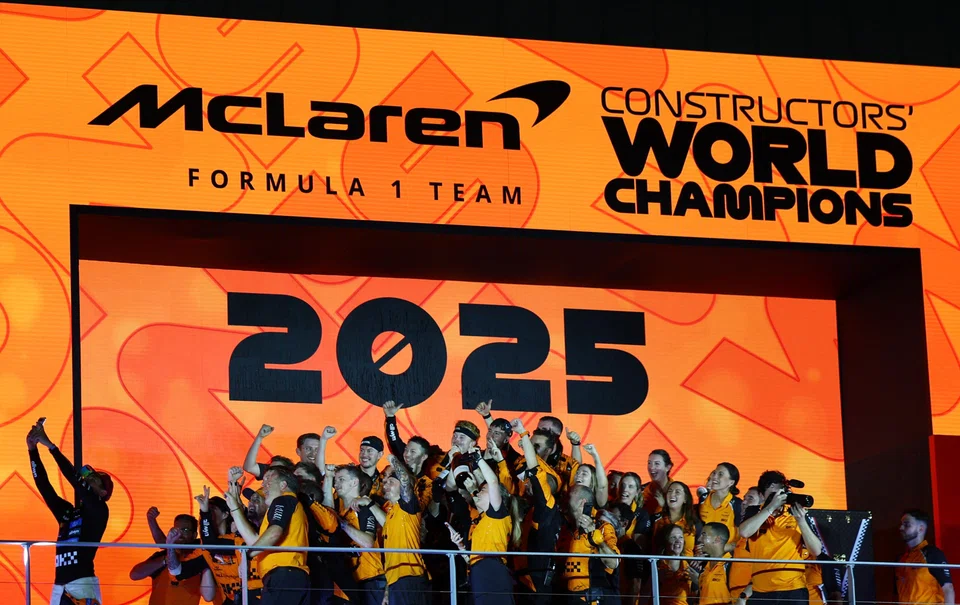 McLaren's Lando Norris taking a selfie with the team on the podium after they won a second consecutive constructors’ title.