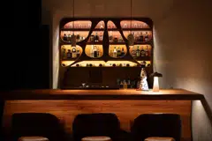 Custom carved wood elements in Gaudi Room evoke Antoni Gaudi's aesthetic.