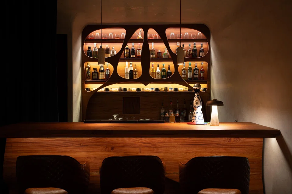 Custom carved wood elements in Gaudi Room evoke Antoni Gaudi's aesthetic.