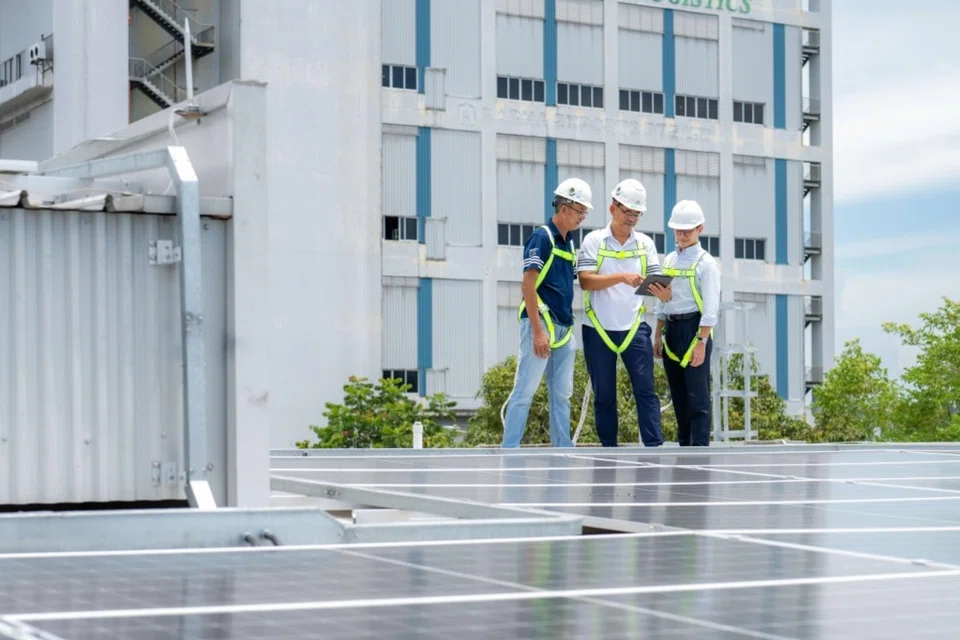 (From left) Shun Yi Cheng Contract Engineering’s project/operations director Kek Chin Heng and managing director Bryant Ng with DBS’ Kenneth Foo from the Regional Strategic Partnerships and Sustainability team, reviewing cost savings and energy efficiency after installing solar panels at the firm’s workers’ dormitories.