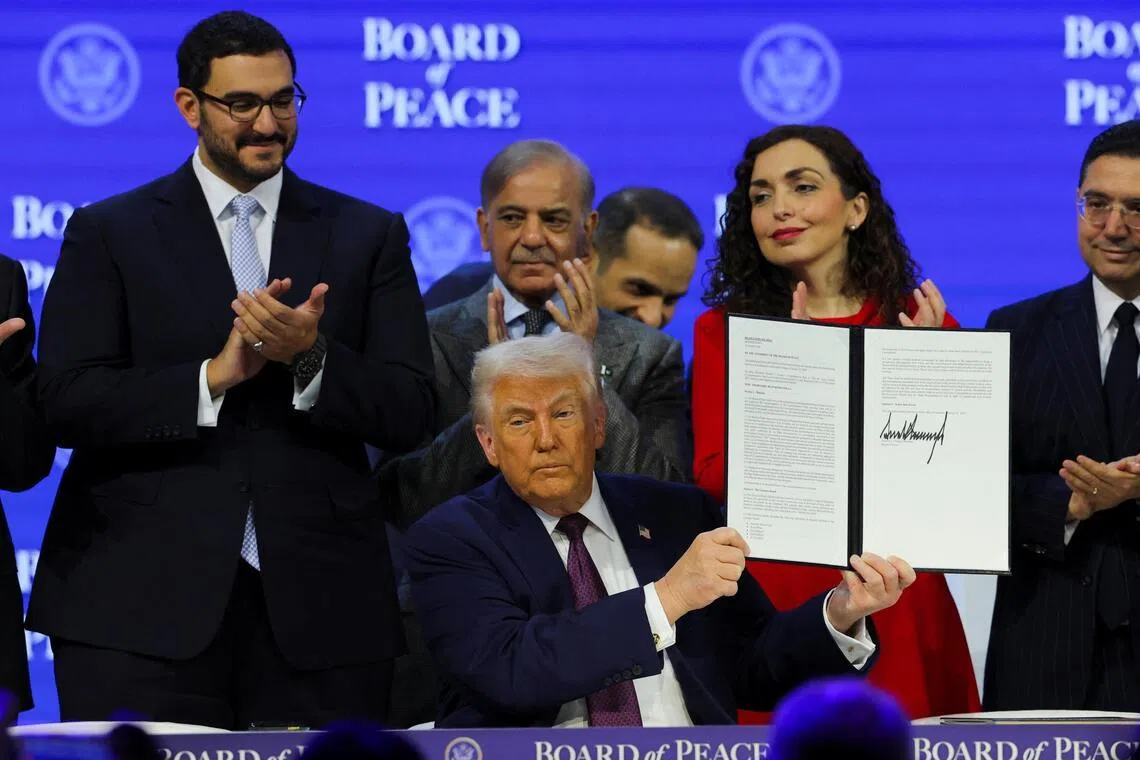 US President Donald Trump holds a signed Charter of the Board of Peace, as he takes part in a charter announcement for his Board of Peace initiative, on Jan 22.