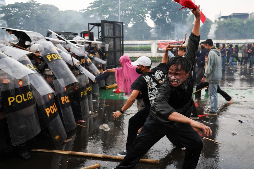 Demonstrators clash with riot police at a protest against what the demonstrators say are exorbitant allowances for Indonesian parliament members, outside Indonesian parliament buildings in Jakarta. 