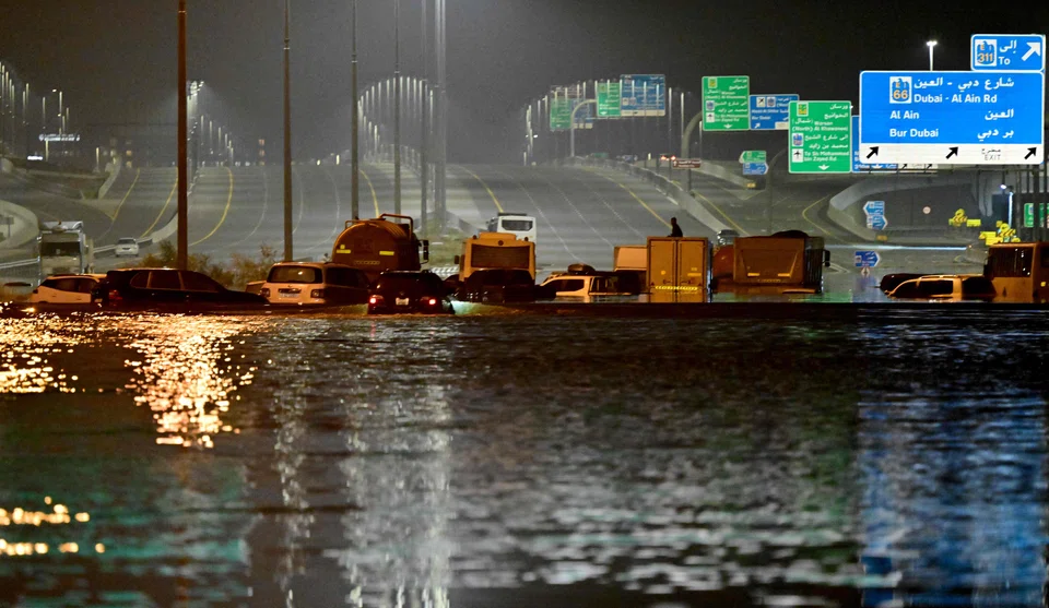 Vehicles are stranded in flood waters along a highway in Dubai following heavy rains on April 18, 2024