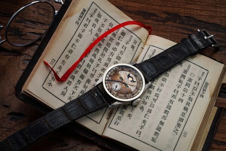 Puyi's Patek Ref 96 and his leather-bound printed edition of Confucius’s Analects.