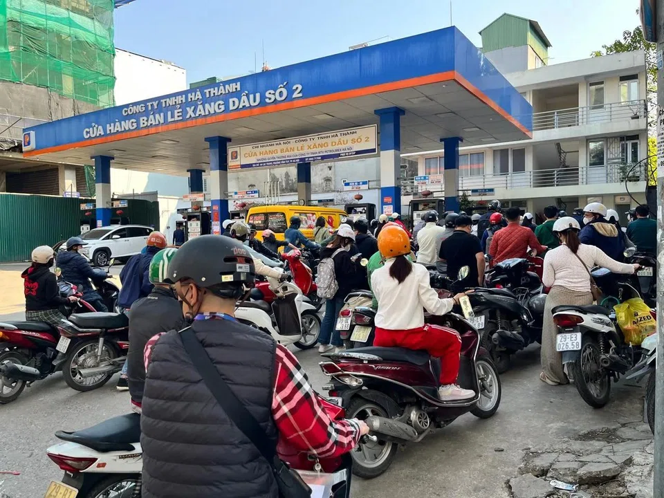 Motorists line up to refuel at a gas station in Hanoi on Mar 10.