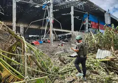 A manis inspecting a garage damaged after Thai air strikes in Poipet town, Banteay Meanchey province, amid clashes along the Cambodia-Thailand border. 