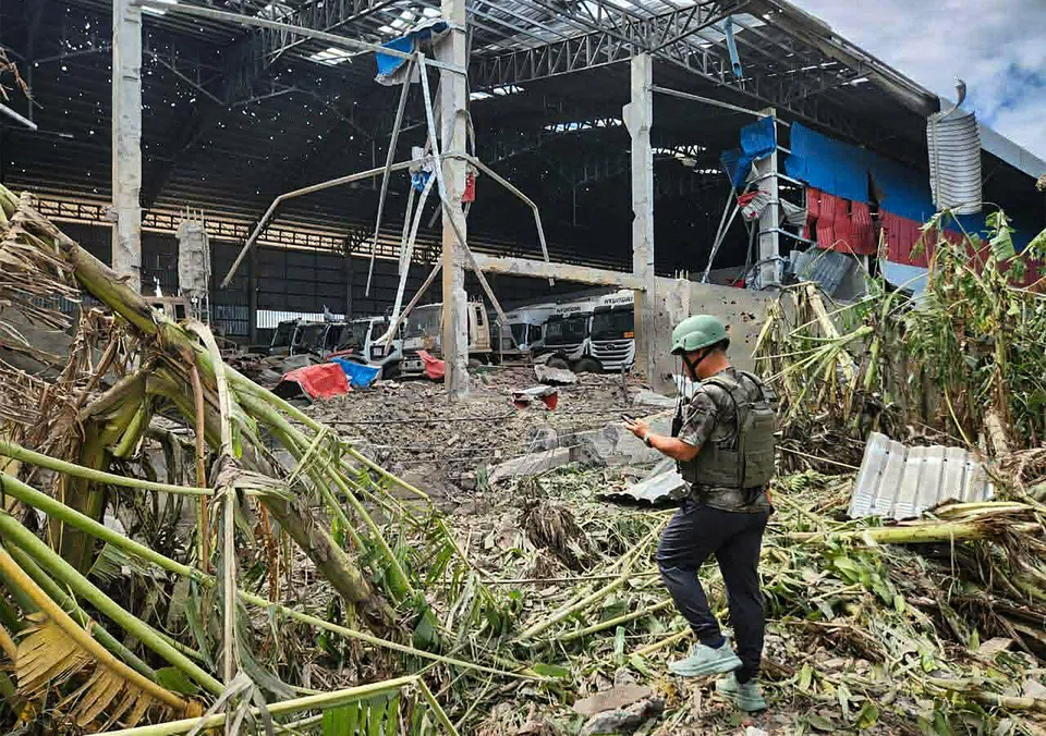 A manis inspecting a garage damaged after Thai air strikes in Poipet town, Banteay Meanchey province, amid clashes along the Cambodia-Thailand border. 