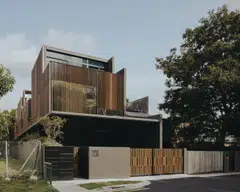Courtyards and a screen facade mitigate the house's long massing. 