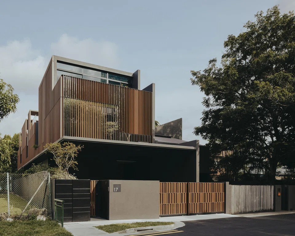 Courtyards and a screen facade mitigate the house's long massing. 