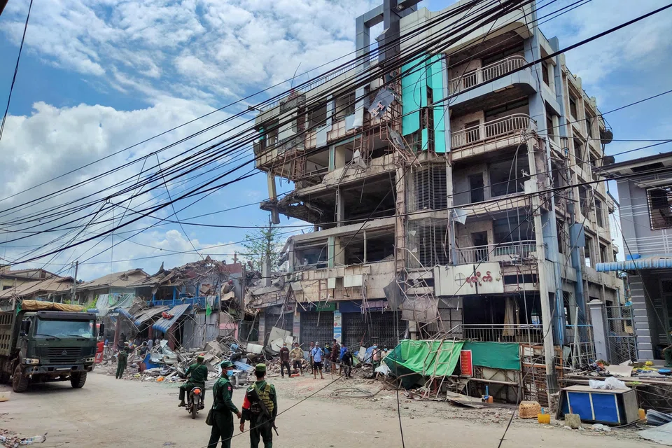 People clean up the debris of a damaged building in the aftermath of bombardments carried out by Myanmar's military in Lashio in Myanmar's northern Shan State on Sept 24, 2024. 