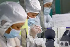 Employees make chips at a factory of Jiejie Semiconductor Company in Nantong, in eastern China's Jiangsu province on March 17, 2021. The “Annual Threat” report singled out China’s dominance in technology sectors including semiconductors, critical minerals, batteries, solar panels and pharmaceuticals. 