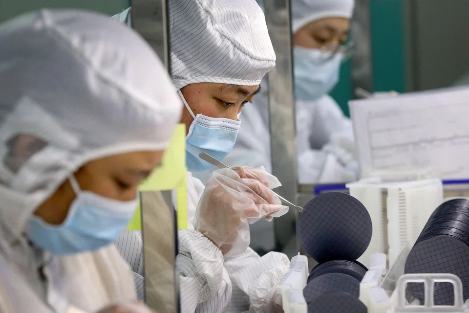 Employees make chips at a factory of Jiejie Semiconductor Company in Nantong, in eastern China's Jiangsu province on March 17, 2021. The “Annual Threat” report singled out China’s dominance in technology sectors including semiconductors, critical minerals, batteries, solar panels and pharmaceuticals. 