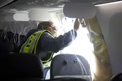 John Lovell, an NTSB inspector in Portland, Oregon, examines the Alaska Airlines plane on Jan 7, 2024, after part of its fuselage blew out midair.