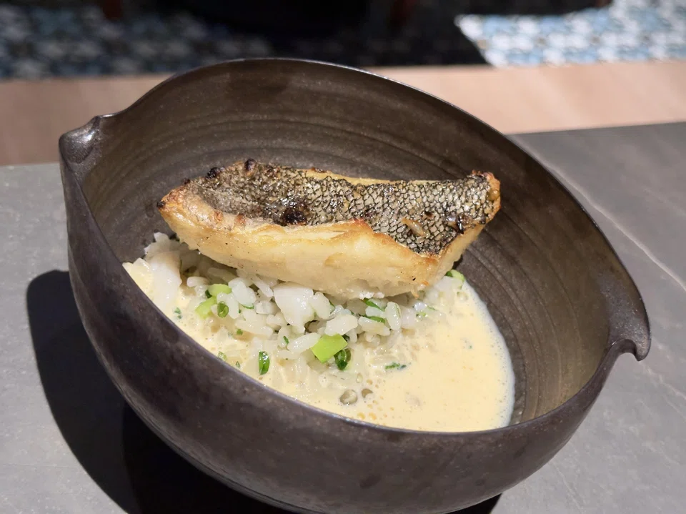 Fried cod fillet on rice with a creamy uni sauce.